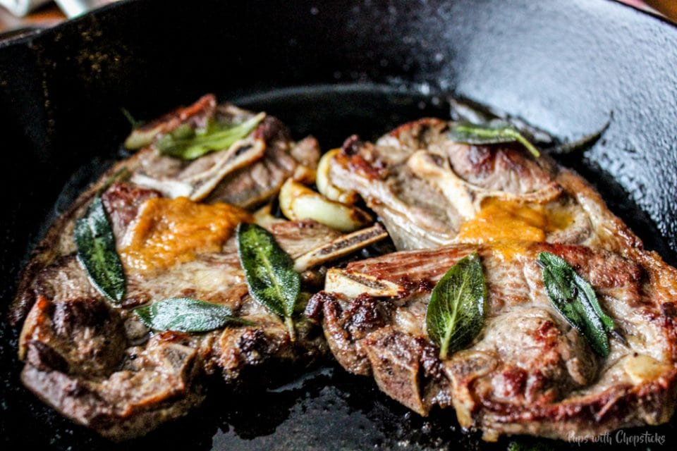 Pan Fried Lamb Chops with melted Miso Butter in a skillet