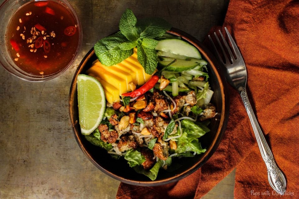 Lemongrass Pork Meatballs (Larb Style) in a bowl with chopped lettuce, mango and a variety of veggies made into a salad