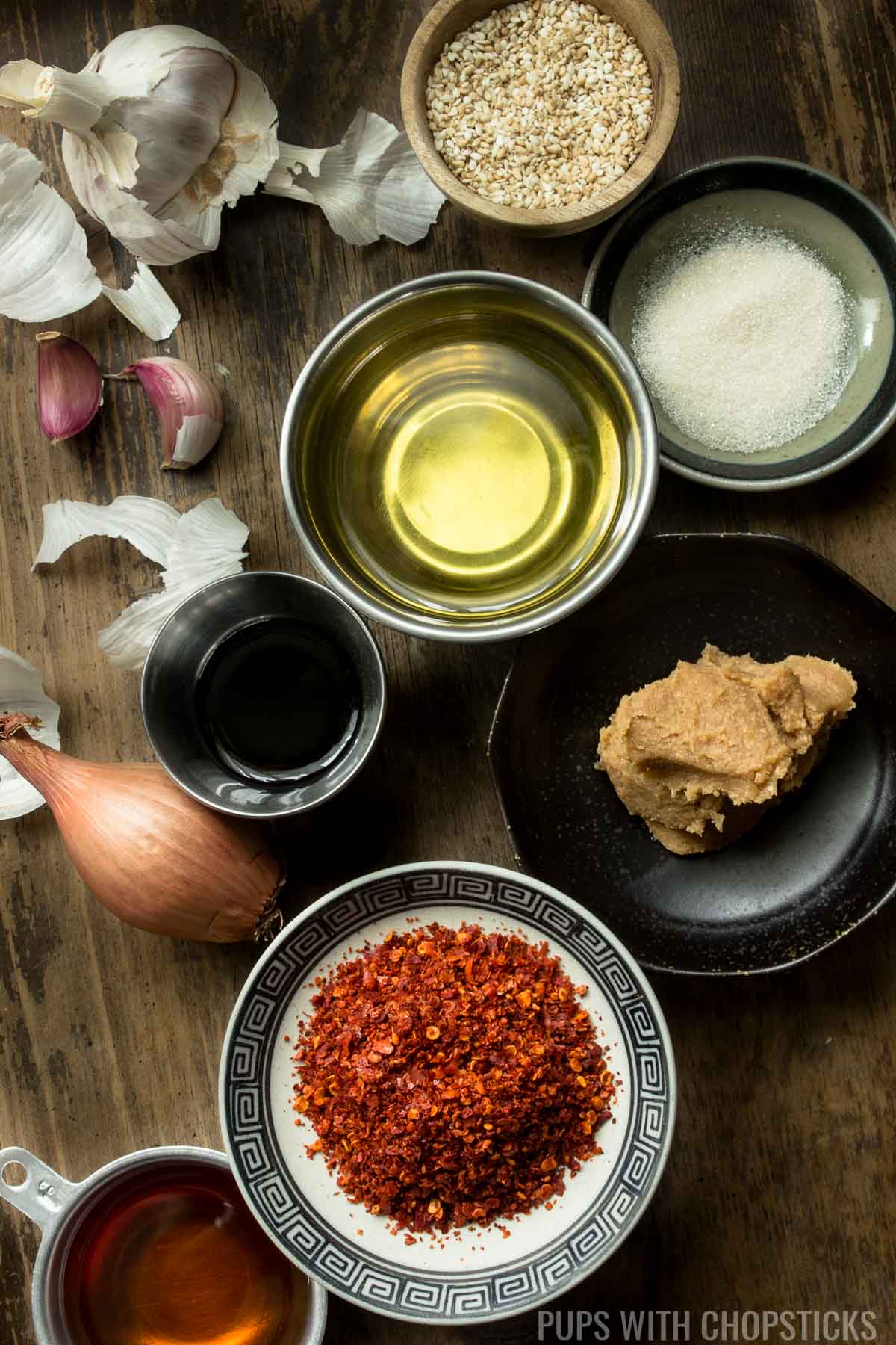 Ingredients for garlic chili oil (chili flakes, shallot, garlic, oil, miso, sugar, soy sauce, sesame seeds)