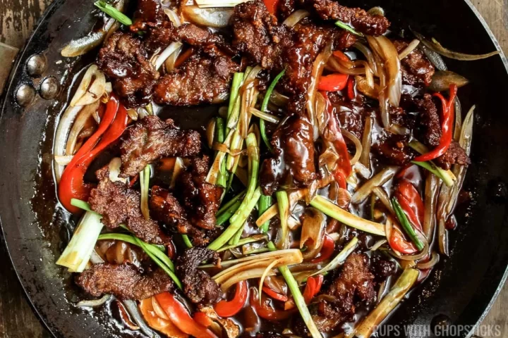 Frying pan with Mongolian beef mixed with sauce
