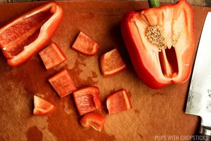 cutting red pepper into cubes.