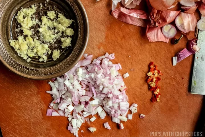 Grated garlic, minced shallots and Thai birds eye chili chopped for prep for the nasi goreng.