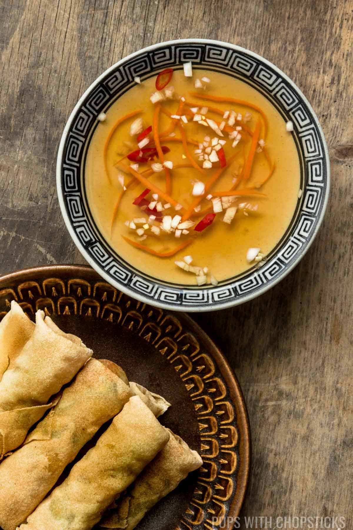 Vietnamese Fish Sauce Dipping Sauce (Nuoc Cham / Nuoc Mam) dipping sauce on a table with spring rolls