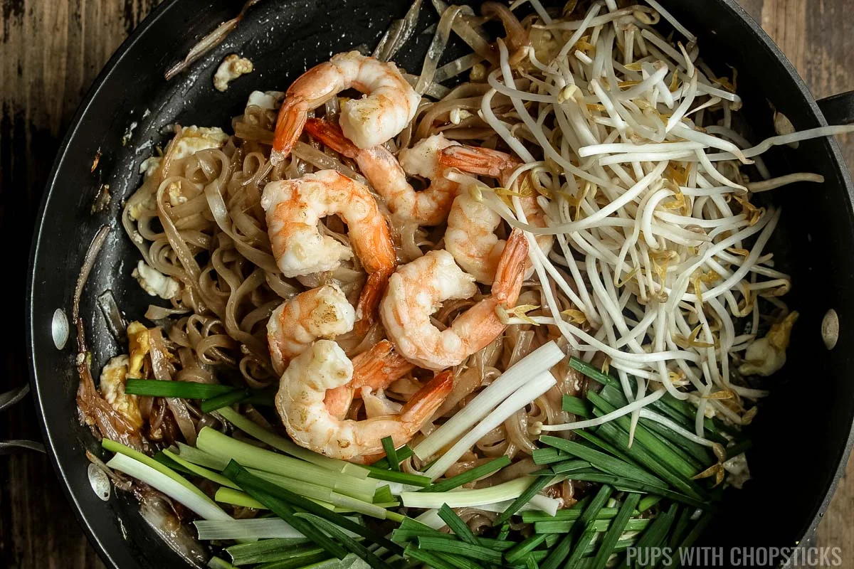 Bean sprouts, shrimp, green onions added back to the pan and cooked for a few seconds in the frying pan.