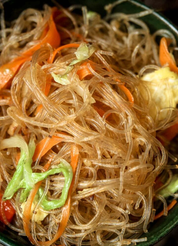 Pad woon sen (Thai glass noodle stir fry) served in a small green bowl