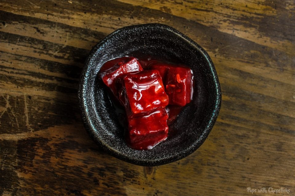 Red fermented bean curd in a small black dish