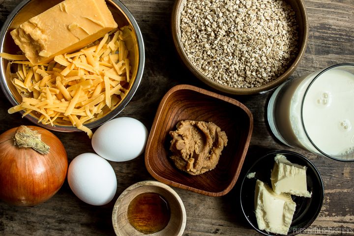 Ingredients for savory oatmeal (cheddar cheese, onions, eggs, steel cut oats, miso, butter, milk)