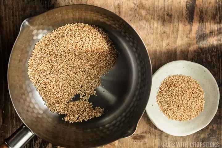 Toasted sesame seeds in a large metal pot for sesame chicken