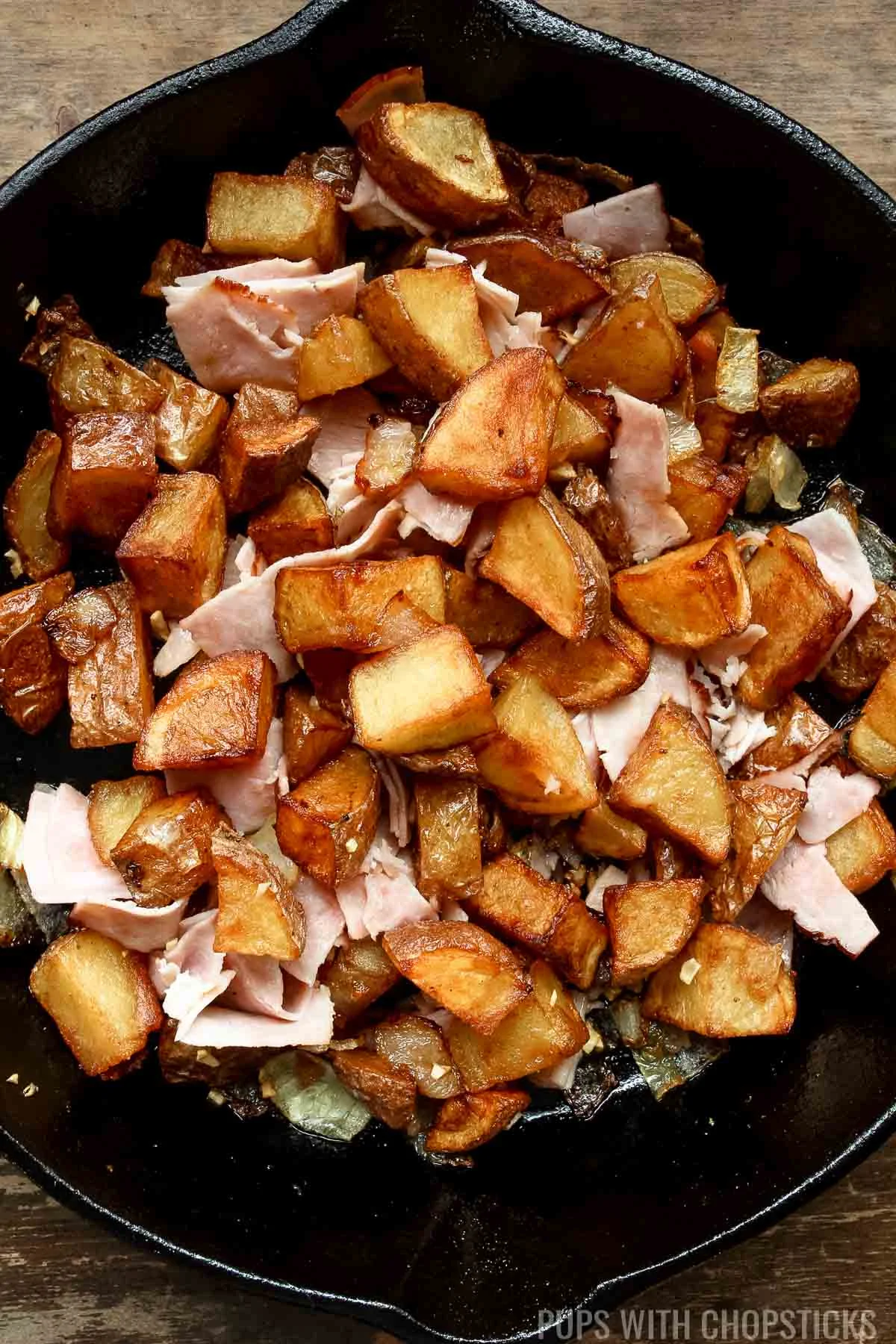 skillet potatoes with onions in a cast iron pan