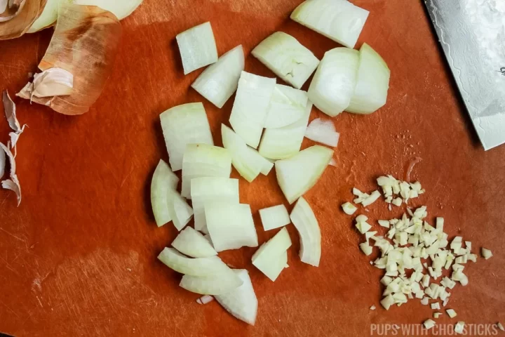 Diced onions and finely minced garlic on a cutting board
