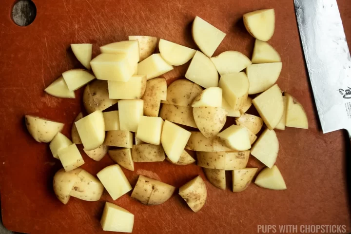 Chopped potatoes on a cutting board.