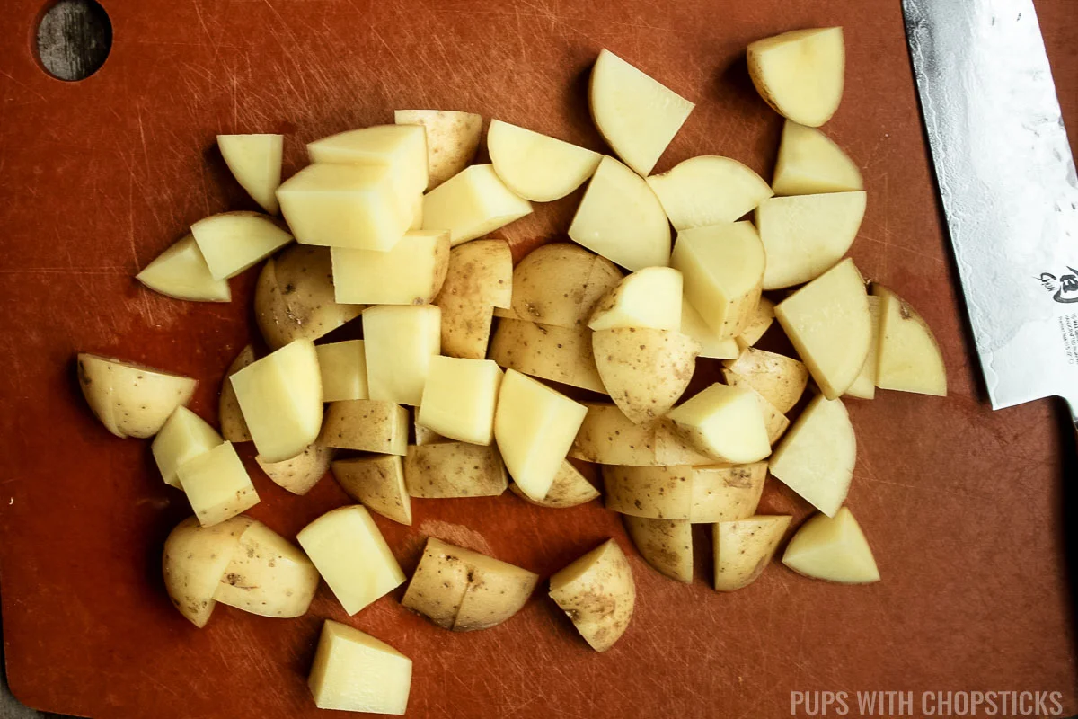 Chopped potatoes on a cutting board.