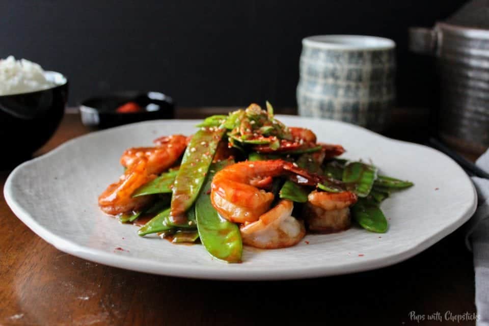 Spicy Garlic Shrimp with Snow Peas on a plate on a table