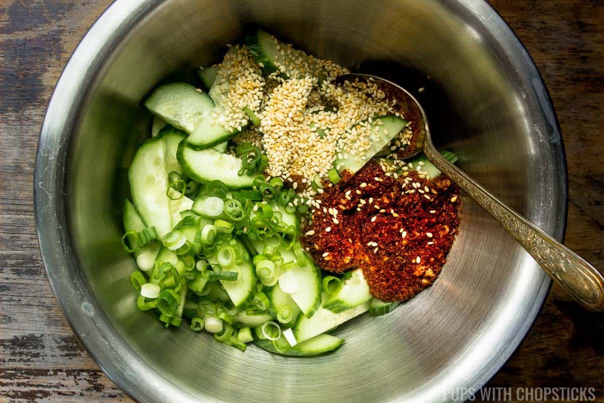 All the ingredients for Korean cucumber salad put into a metal bowl right before mixing.