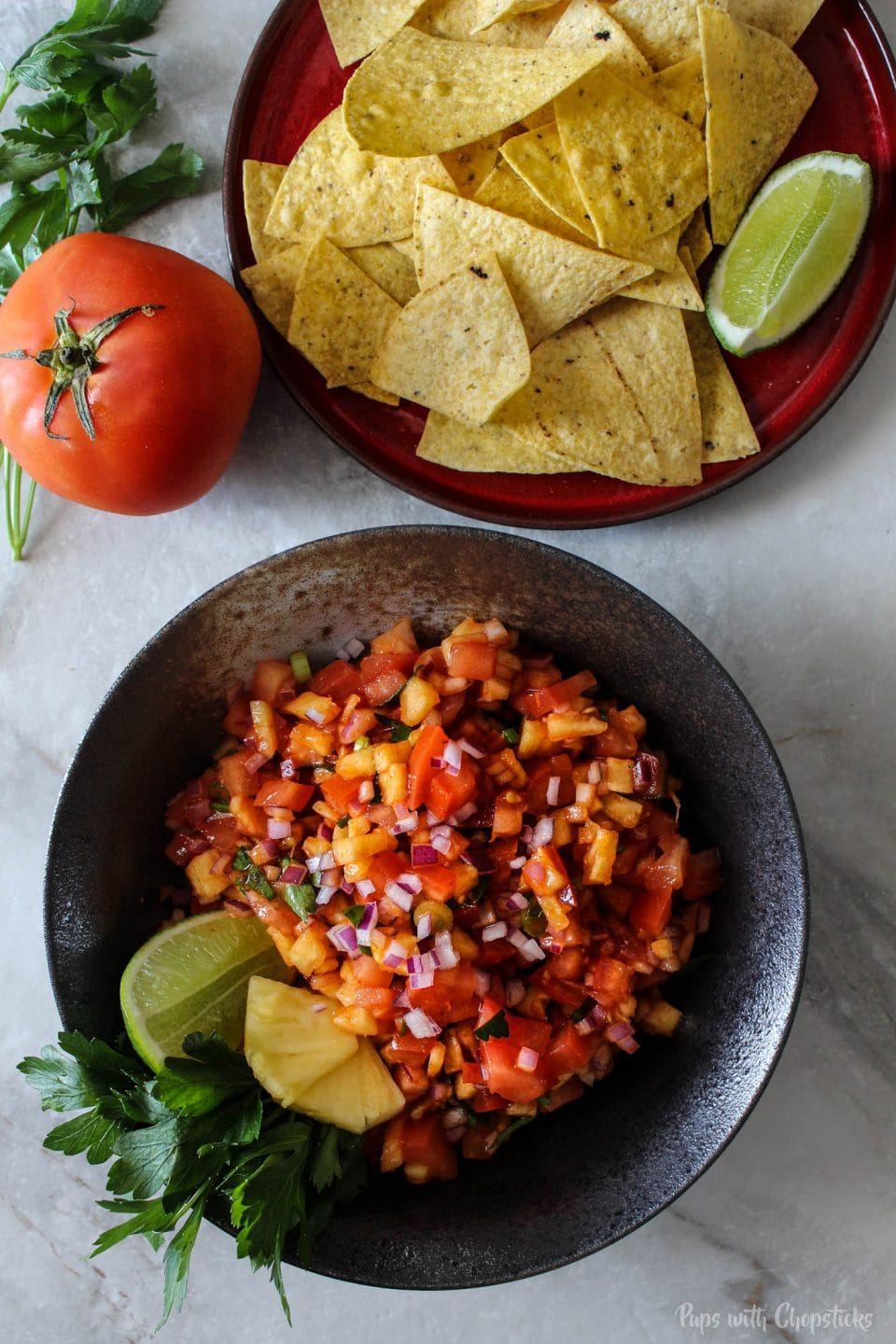 A bowl of pineapple salsa served with a side of tortilla chips