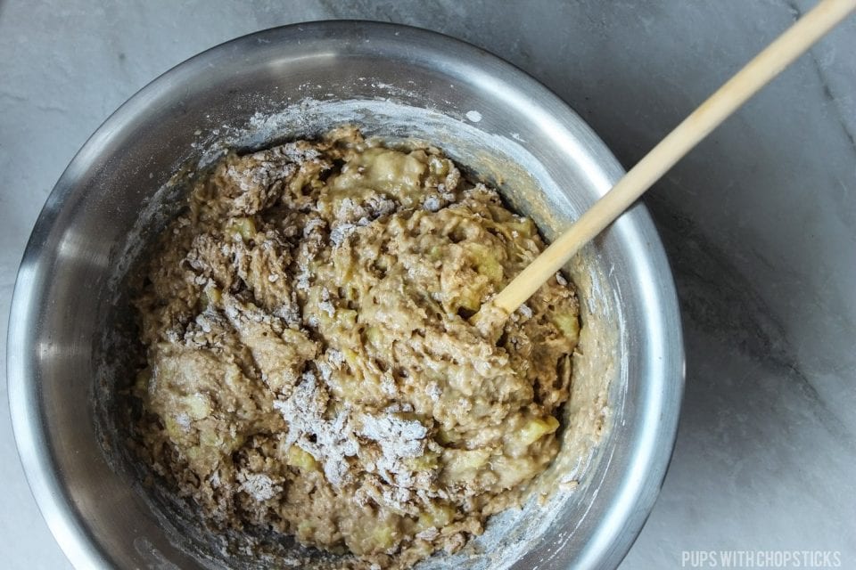 Banana bread batter mixed together with flecks of flour, to show not to over mix the batter