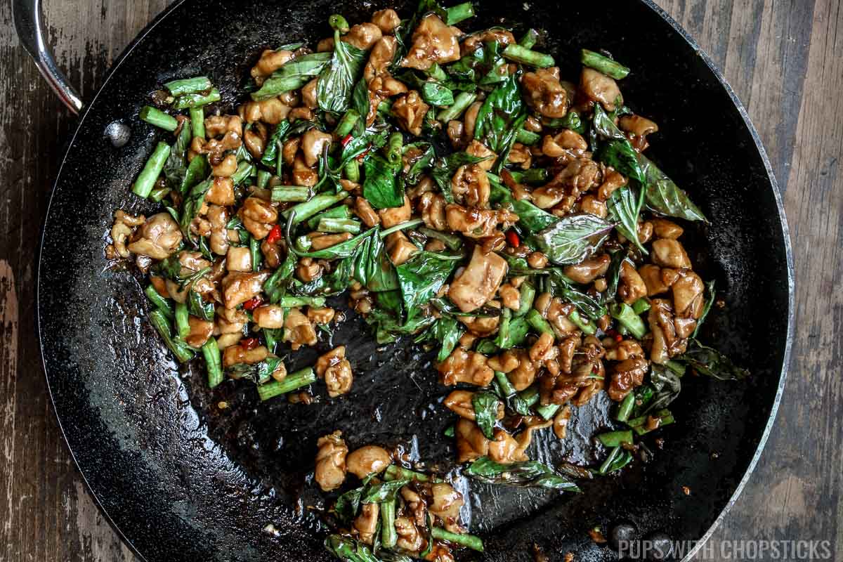 Thai basil leaves added into the pan and wilted with the residual heat with the stove off.