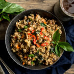 Turkey Thai Basil Fried Rice in a black bowl on a wooden table