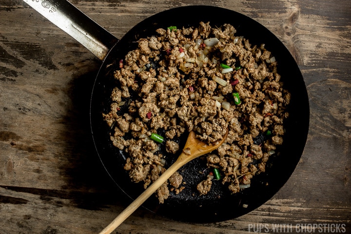 Ground turkey being cooked in a frying pan with garlic, onions, chilies and ginger for Turkey Fried Rice