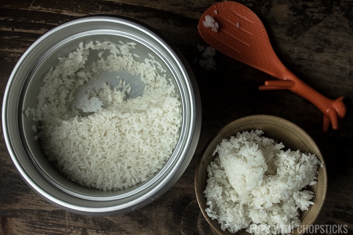 Fresh cooked rice in a pot with a spatula on the side