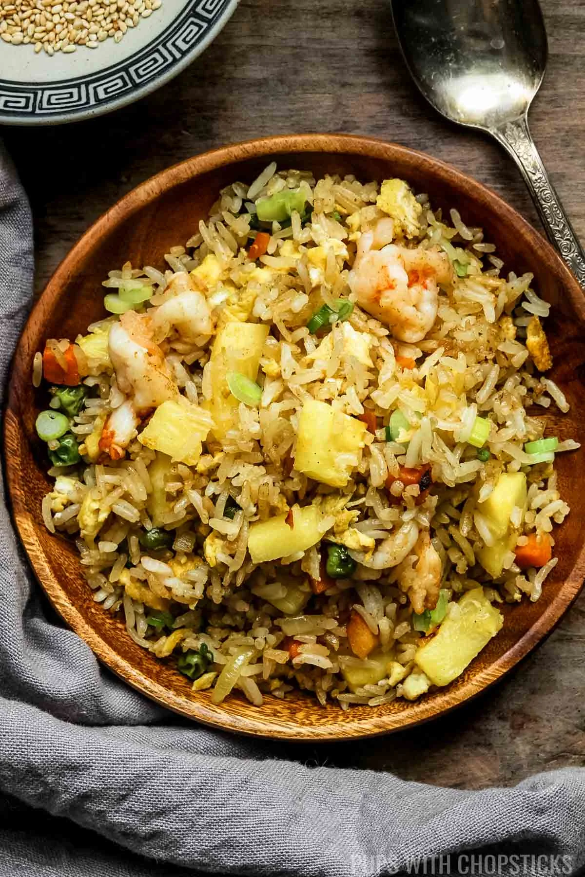 thai pineapple fried rice in a wooden plate.