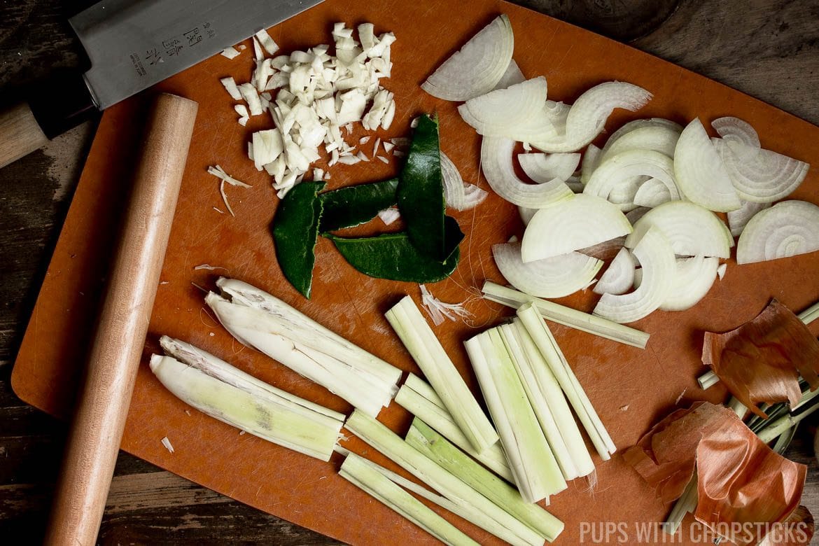 Lemongrass being smashed to release its oils and flavors