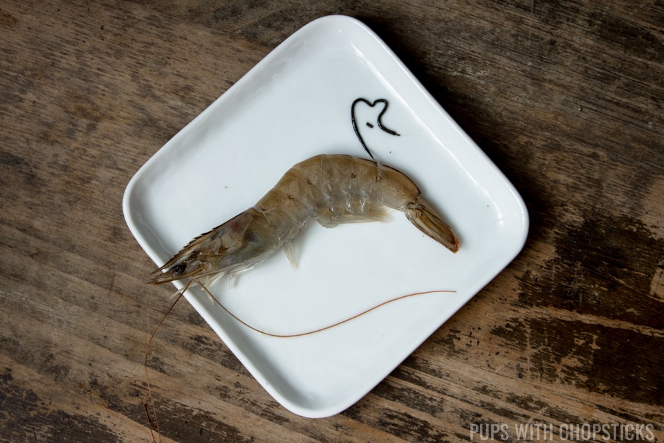Shrimp being deveined on a plate