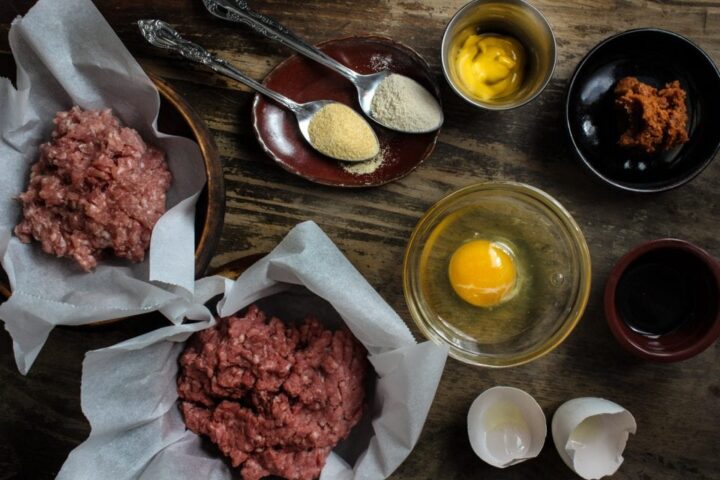 Ingredients laid out for how to make beef and pork burgers (ground beef, ground pork, garlic and onion powder, mustard, miso)