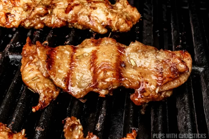 Lemongrass chicken being grilled on a grill