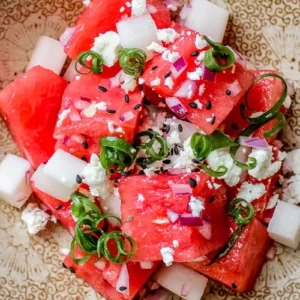 Closeup of Watermelon Feta salad with green onions and sesame seeds