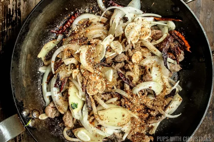 add xinjiang spices to frying pan.