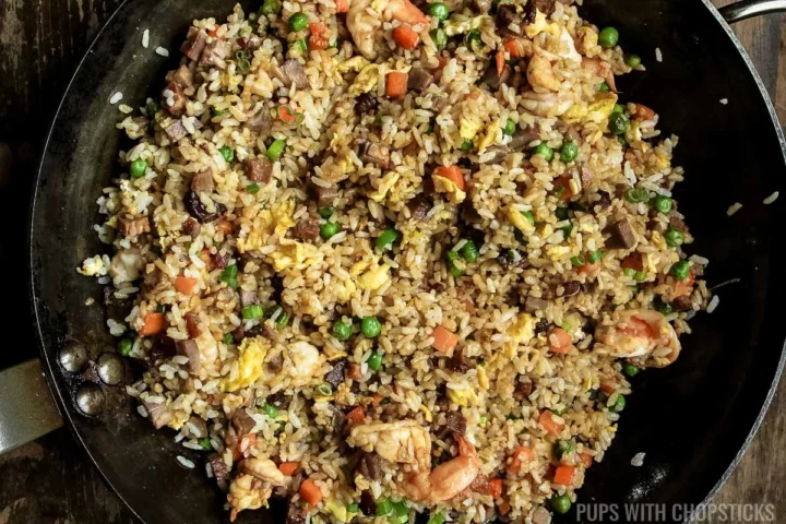 yeung chow fried rice completed in a frying pan.