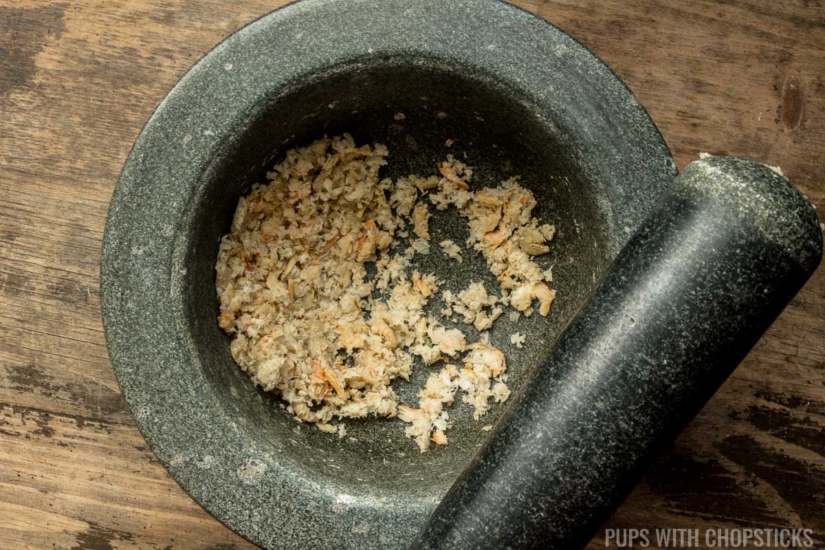 Mortar and pestle with dried shrimp pounded inside
